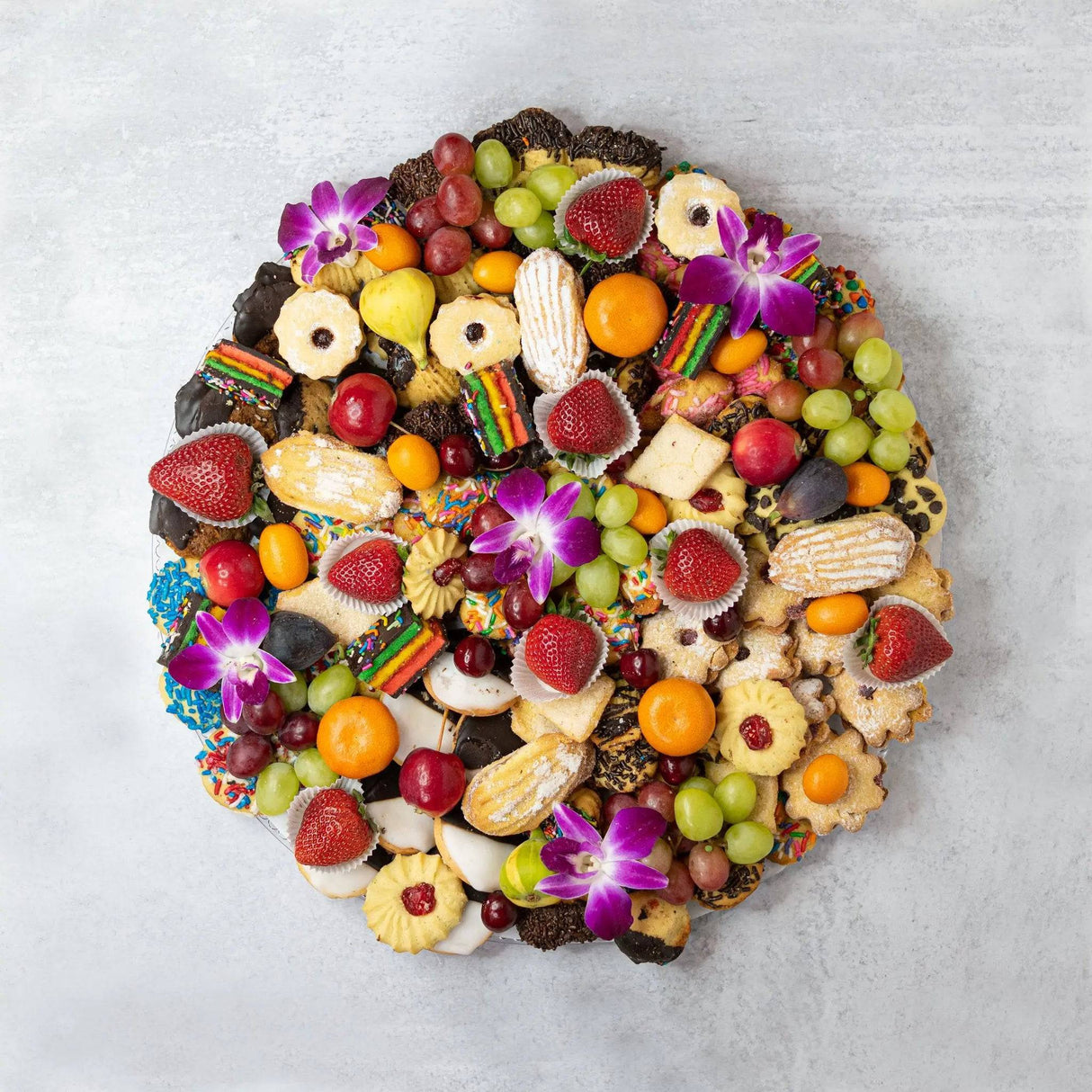 Large dessert platter bakery cookies strawberries grapes kiwi plums cherries