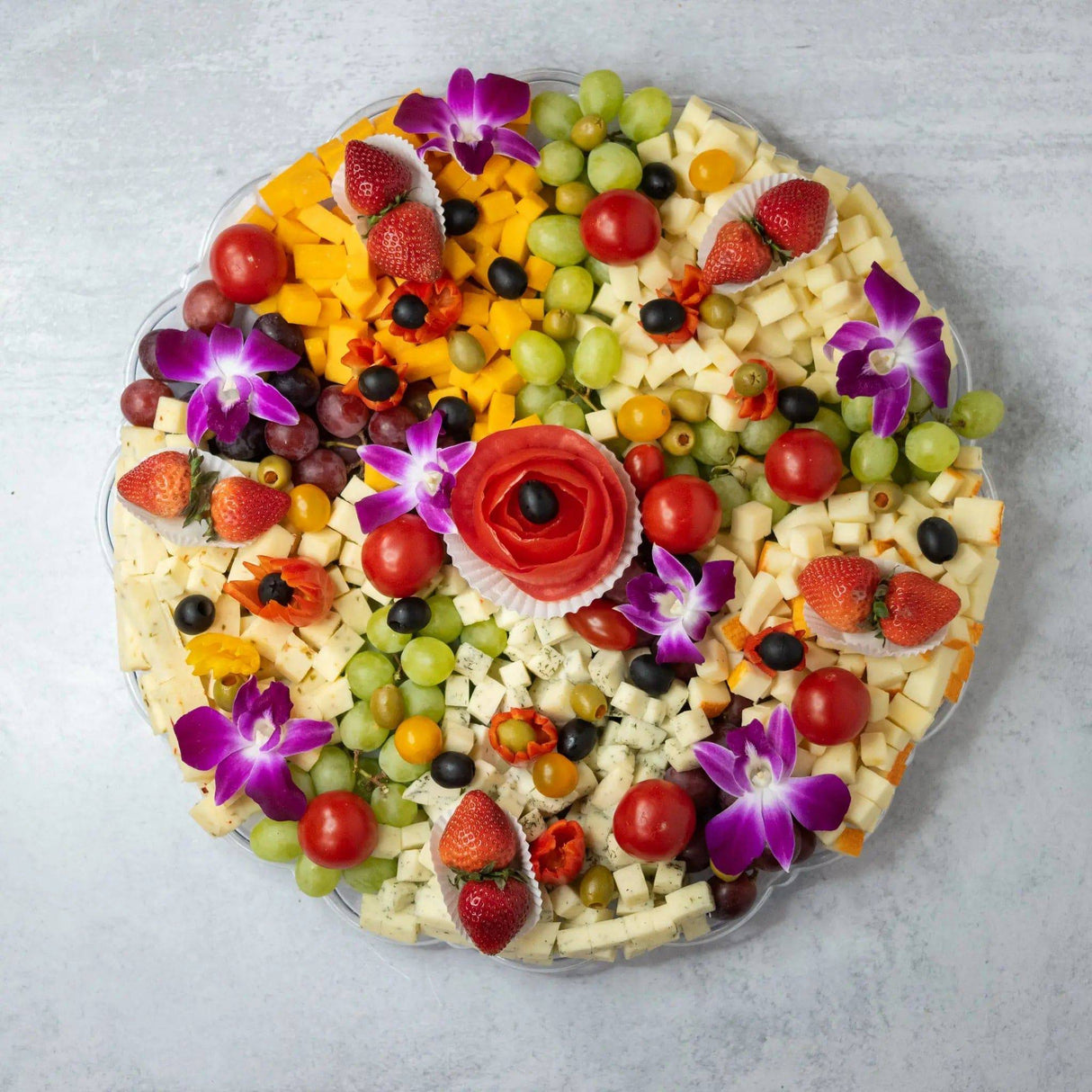 Gourmet cheese fruit platter assorted cheeses strawberries grapes olives tomatoes